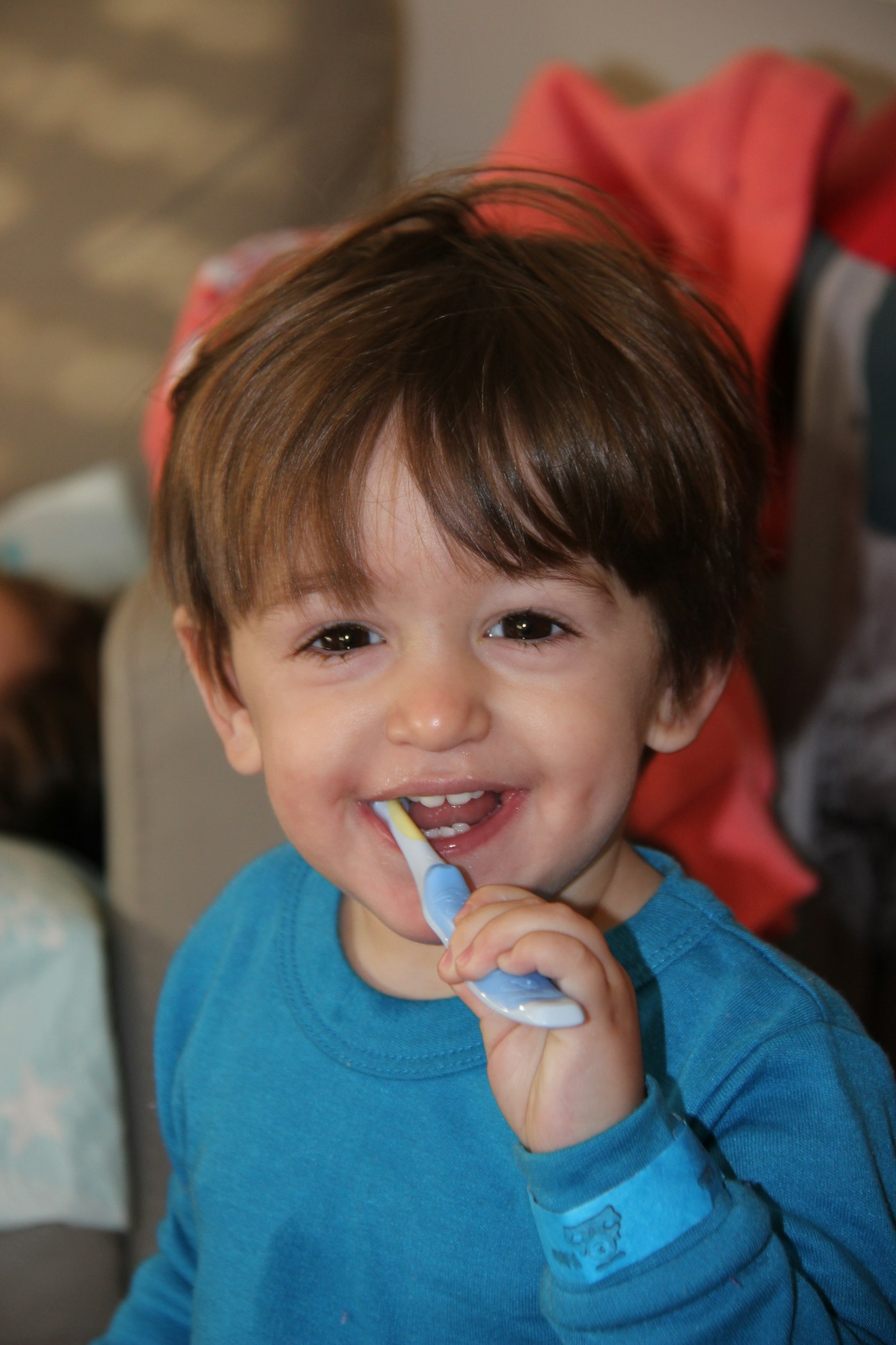 Smiling boy brushing his teeth