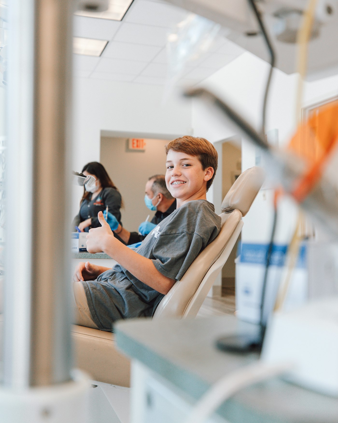 Smiling teenager with braces in the dental chair